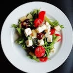 Delicious Greek salad featuring fresh vegetables and creamy feta cheese, perfect for a healthy meal.